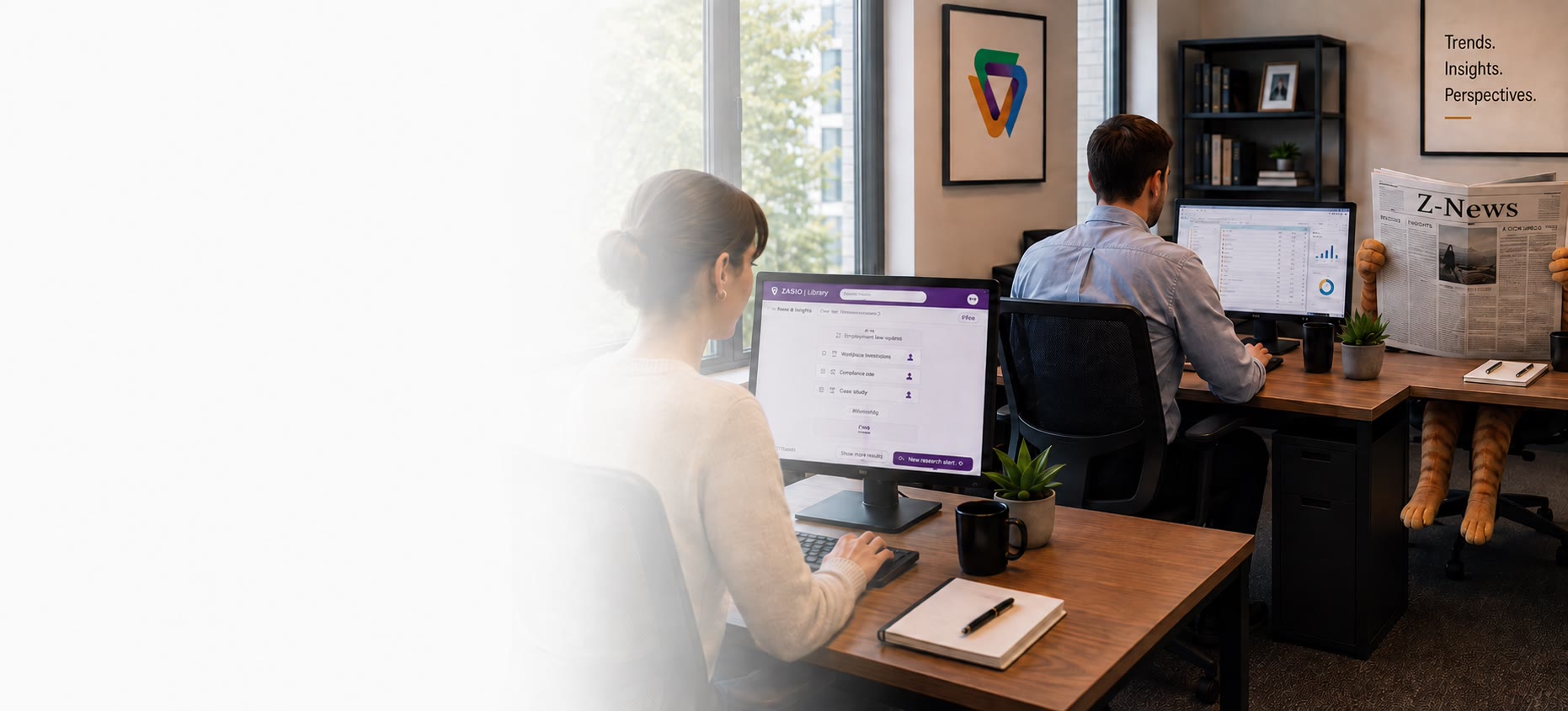 The Zasio research desk — the Zasio Library open on one monitor showing research alerts, a colleague working at another, an office cat behind a copy of Z-News, and a print on the wall reading Trends. Insights. Perspectives.